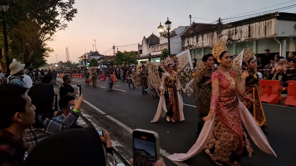 Spectators watching a batik carnival parade in Solo