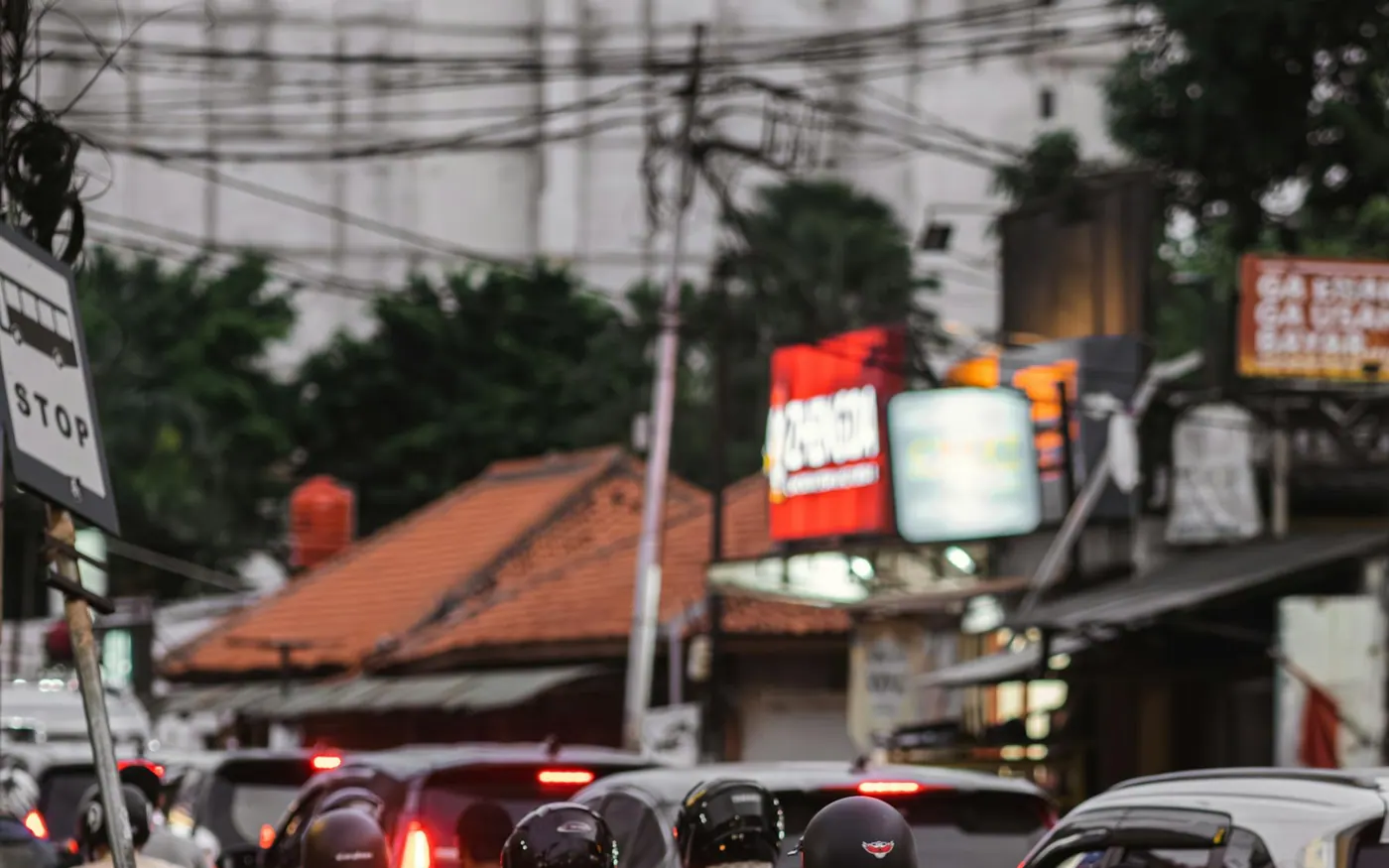 Scooter and road safety is the main Bali safety trade-off for many tourists Dense street traffic with motorbikes and cars in an Indonesian city