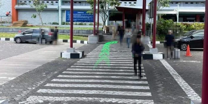 Grab official DPS image showing the crossing before the parking building at Bali Airport.