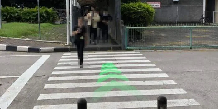 Grab official DPS image showing the motorcycle parking hallway route at Bali Airport.