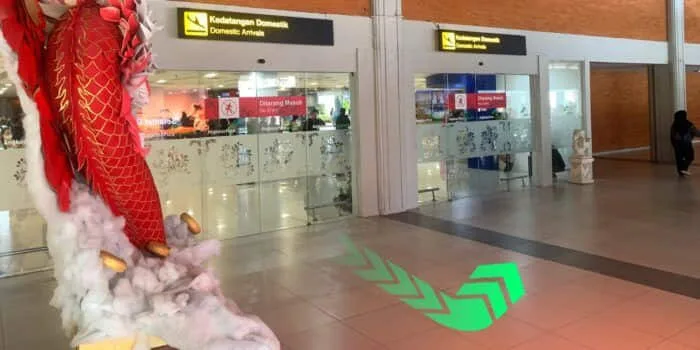 Grab official DPS image showing the domestic arrivals exit route at Bali Airport.