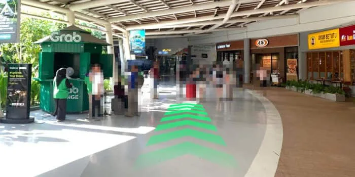Grab official DPS image showing the domestic route near A&W at Bali Airport.