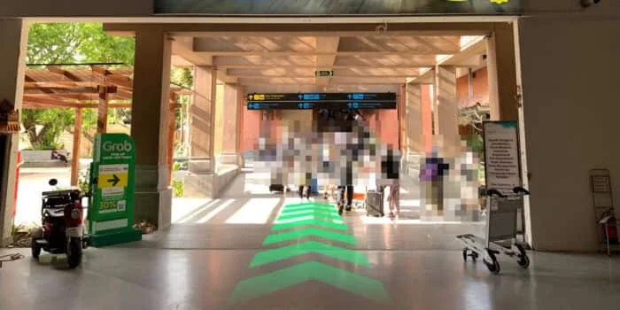 Grab official DPS image showing the domestic escalator route toward GrabCar pickup.