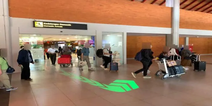 Grab official DPS image showing the domestic premium route from baggage claim.