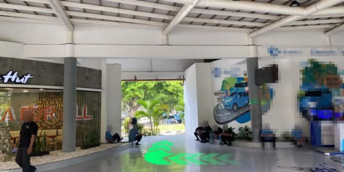 Grab official DPS image showing the route toward the GrabCar Premium pickup point.