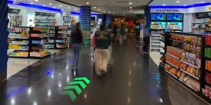 Grab official DPS image showing the international arrivals route toward the terminal exit at Bali Airport.