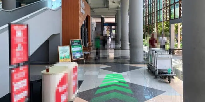Grab official DPS image showing the Grab Lounge dispatcher area at Bali Airport.