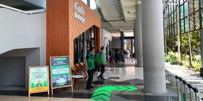 Grab official DPS image showing the turn from Grab Lounge toward the international pickup point.