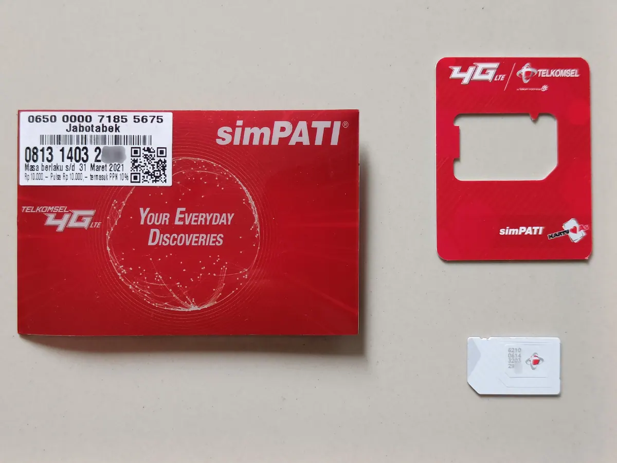 Local Indonesian SIM card option compared with Bali travel eSIMs Indonesian Telkomsel prepaid SIM card package and SIM card on a table